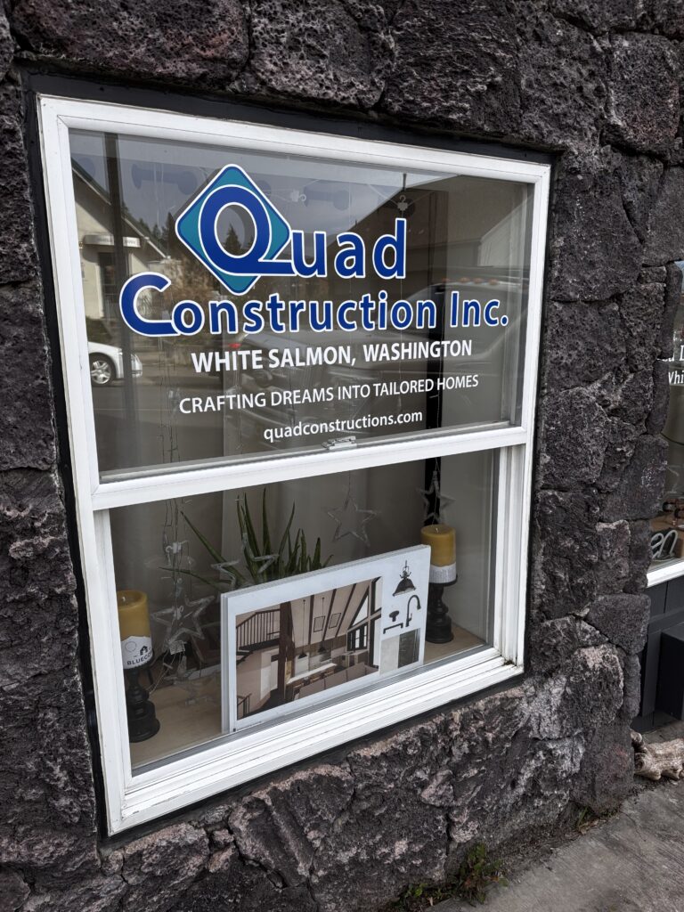 A newly installed window displays the Quad Construction logo.